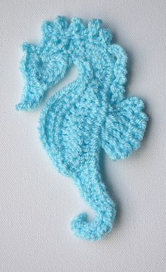 a crocheted seahorse on a white background