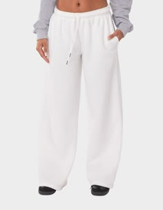 These Wide-Leg, Low-Rise Sweatpants Are The Ultimate Choice For A Cozy And Effortless Look. Perfect For Lounging Or Running Errands, Their Comfortable And Relaxed Fit Ensures You'll Feel Stylish And Comfortable All Day Long. Sweatpants. Low Rise Waist. Adjustable Waistband. Wide Leg. Model Wears Size S. Model Height Is 5'7. Item Care: Wash With Similar Colors. 50% Cotton, 50% Polyester. | Edikted Kamari Low Rise Wide Sweatpants Clothes Sweatpants, Thrifted Tops, Aesthetic Sweatpants, Wide Sweatpants, Need Outfits, Low Rise Sweatpants, Long Sweatpants, 2025 Wishlist, Basic Clothing