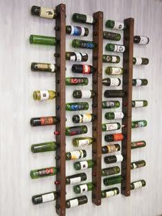 a wall mounted wine rack filled with lots of bottles