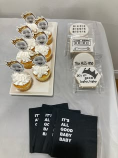 a table with cupcakes, napkins and other items on top of it