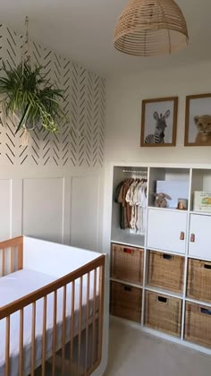 a baby's crib in the corner of a room with shelves and baskets