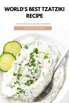 a white plate topped with cucumber and cream sauce next to a fork on top of it