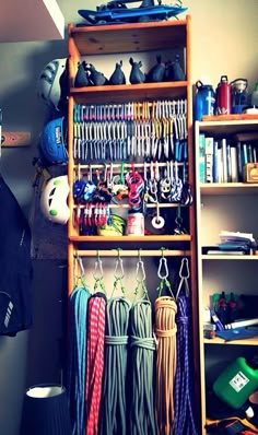 a shelf filled with lots of different items next to a wall mounted rack full of hats and scarves