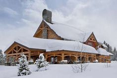 a large wooden house covered in snow