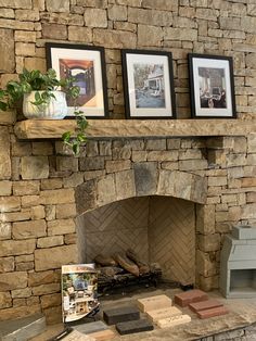 a stone fireplace with pictures on the mantle