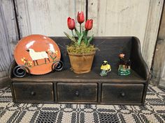 a wooden table topped with a potted plant and figurines