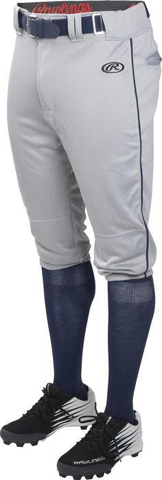 a baseball player in white and blue pants with his feet on the base ball shoe