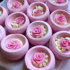 there are many pink cupcakes with flowers in them