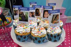 cupcakes with white frosting and sprinkles are on a plate