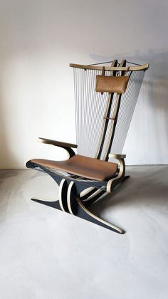 the chair is made out of wood and has an unusual design on it's back