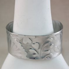 Wide Cuff Bracelet Aluminum Wide Metal Cuff Bracelet - Whimsical Pattern - Textured Cuff Bracelet This is an aluminum cuff bracelet with a whimsical hearts textured pattern pressed in the metal. The cuff bracelet measures 1-1/4" x 6", The bracelet is textured, then the corners rounded, then polished to a high polished - brushed metal finish. This bracelet is VERY light weight, gorgeous and fun to wear. You will love it :) Aluminum is nickel free and hypo allergenic ****************************** Whimsical Heart, Metal Cuff Bracelet, Wide Cuff Bracelets, Cuff Jewelry, Wide Bracelet, Wide Cuff, Brushed Metal, Jewelry Bracelet, Silver Cuff