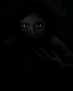 a woman is hiding in the dark with her hands on her chest and eyes wide open