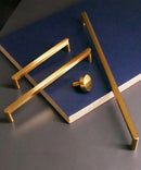 two pieces of brass furniture sitting on top of a blue table