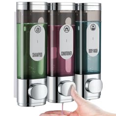 a hand is pointing at three different colored liquids in the same container, each containing an individual's finger