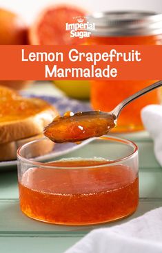 a spoon full of lemon grapefruit marmalade on top of a table