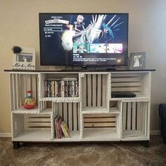 there is a television that is on top of a book shelf in the living room