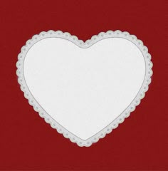 a white heart shaped frame on a red background