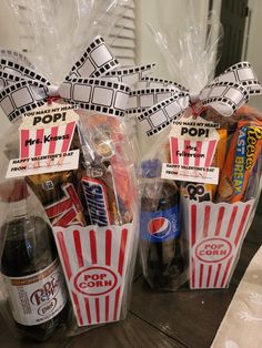 two bags filled with snacks and drinks on top of a table