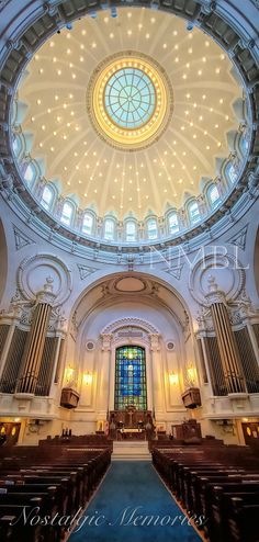 the inside of a church with pews and stained glass windows on the ceiling is shown