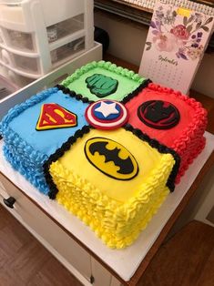 a birthday cake decorated to look like superheros