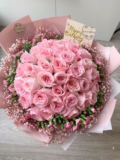 a bouquet of pink roses and baby's breath