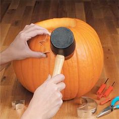 a person carving a pumpkin with a large knife