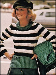 a woman wearing a black and white striped sweater with green purses on her shoulder