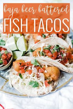 several tacos on a plate with limes and cilantro