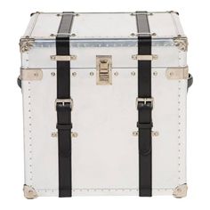 a white trunk with black straps and studded trims on the bottom is shown