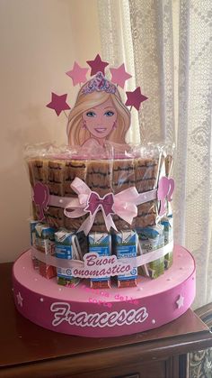 a cake made to look like a barbie doll with cookies and candies in it