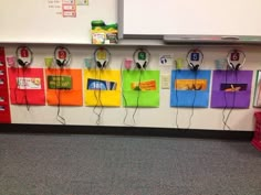 a classroom wall with headphones hanging from it's sides and on top of each other