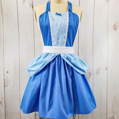 a blue dress with white trim on the waist