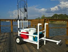 a fishing pole and bucket cart on a dock