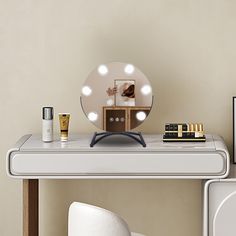 a table with a mirror, makeup and other items sitting on it next to a white chair