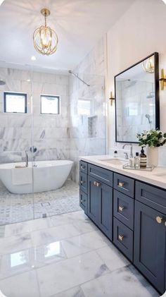 a bathroom with marble flooring and white walls, along with an oval bathtub