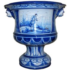 a blue and white vase with an image of a man fishing in the water on it