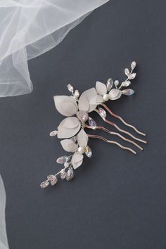 Pearl hair comb, Flower hair comb, Floral hair comb, Bridal hair comb floral, Resin comb, Rhinestone hair comb, Bridal hair piece, Hair fork Our pretty and elegant floral hair comb is a perfect choice for a modern bride. The flowers are made of UV resin, that is the new trend in handmade jewelry. Each petal is created manually. The comb is finished with Swarovski crystals and Cubic Zirconia gems to enhance its design and shape. The price is for the hair comb - Available in gold/rose gold and silver-tone. - The color and size of flowers we can make according to your preferences. - Suits a range of hairstyles - Measurements approx.: 5.70 inches (14.5 cm) - Comes in a beautiful signature box! Custom orders are welcome! Feel free to contact us!! Please NOTE!! All of our products are handmade, Resin Comb, Pearl Bridal Headpiece, Bridal Hair Pins Pearl, Pearl Hair Comb, Floral Hair Comb, Bridal Hair Combs Pearl, Floral Resin, Gold Hair Comb, Pearl Hair Combs