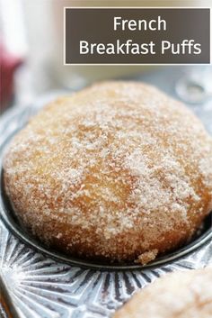 french breakfast puffs with powdered sugar on top in a muffin tin, ready to be eaten