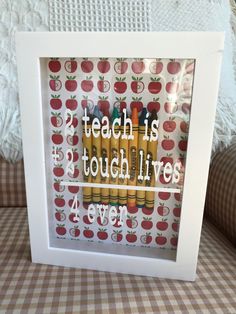 an art print with the words teach is tough like love and crayons on it