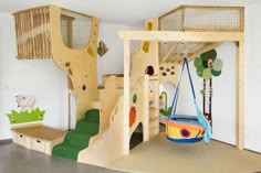 children's play area with slide, climbing wall and swing set for indoor play