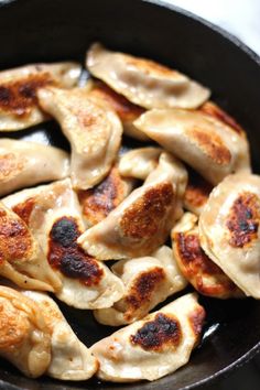 some dumplings are cooking in a skillet