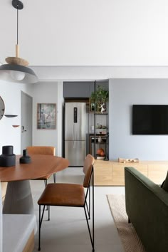 a living room filled with furniture and a flat screen tv mounted to the side of a wall