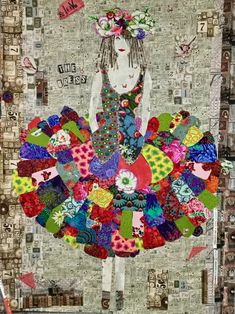 a woman in a colorful dress made out of fabric and paper collages with words on it