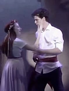 the man and woman are dancing together on stage