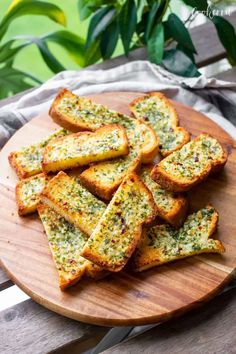 slices of garlic bread on a wooden plate