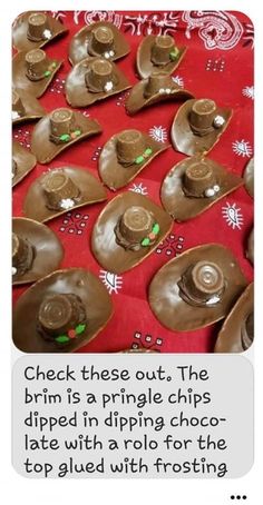 some chocolate covered spoons sitting on top of a red tablecloth with white and green decorations