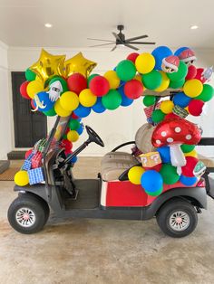 a golf cart decorated with balloons and gifts