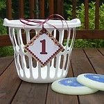 two cookies sitting on top of a wooden table next to a white basket with one