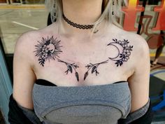 a woman with a sun and moon tattoo on her chest