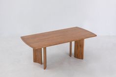 a wooden table sitting on top of a white floor